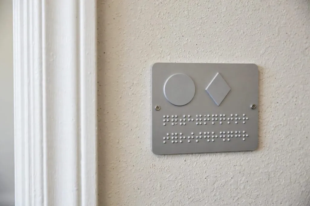 ADA braille room identification sign on wall