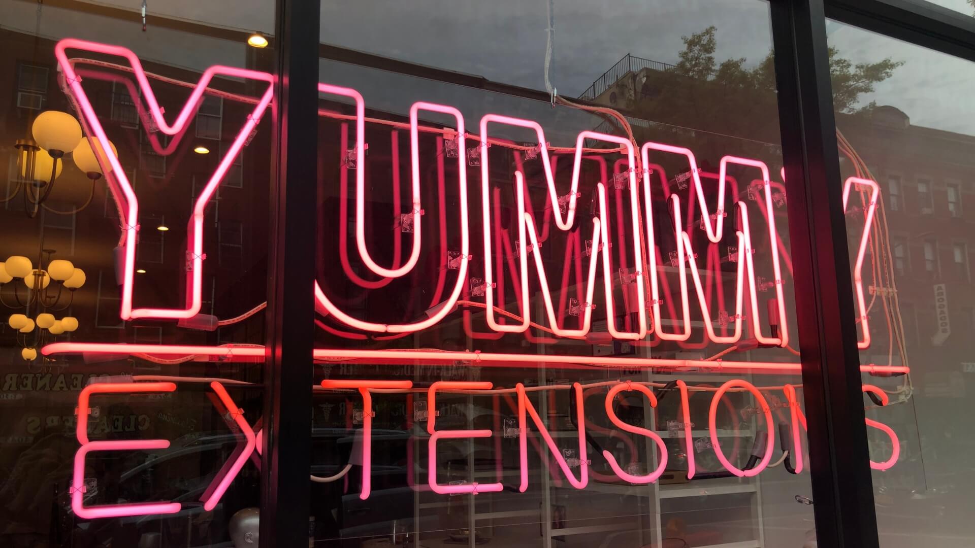neon sign for yummy extesions