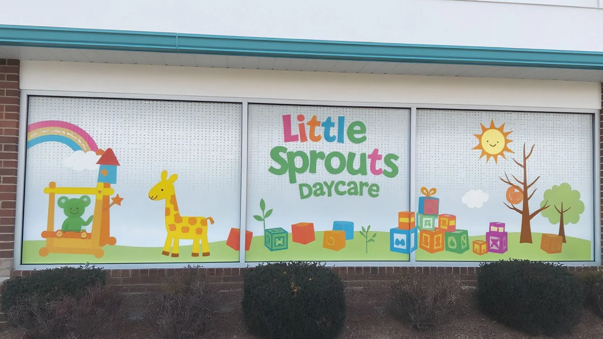 daycare perforated window wrap with cartoon animals and playful design