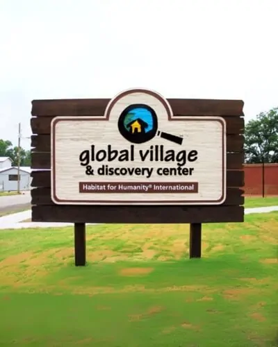 global village carved sign