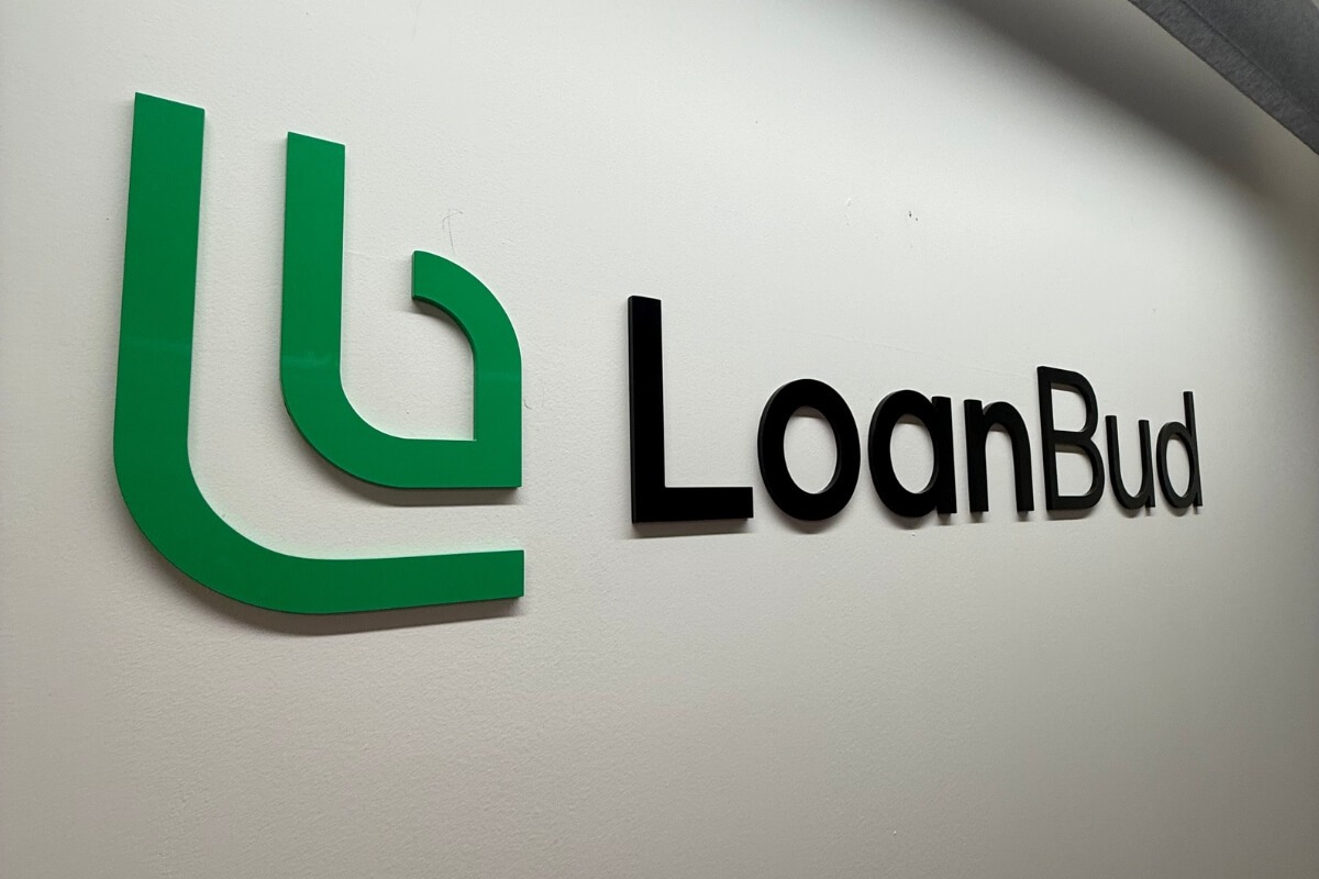 LoanBud green and black acrylic office signage