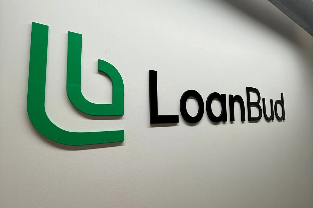 LoanBud green and black acrylic office signage
